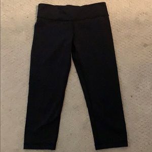 Black Ivivva leggings and a colorful sports bra